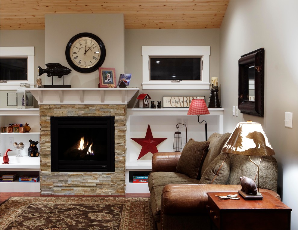 This is an example of a traditional living room in Minneapolis with a stone fireplace surround.