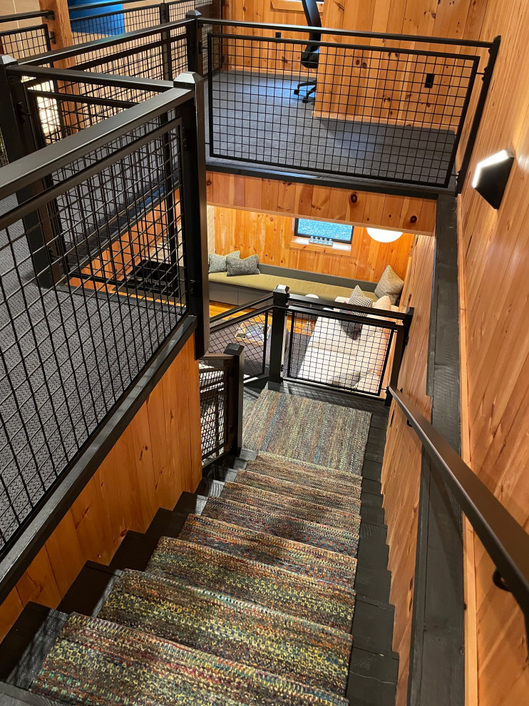 Medium sized wood l-shaped metal railing staircase in Boston with wood risers and wood walls.