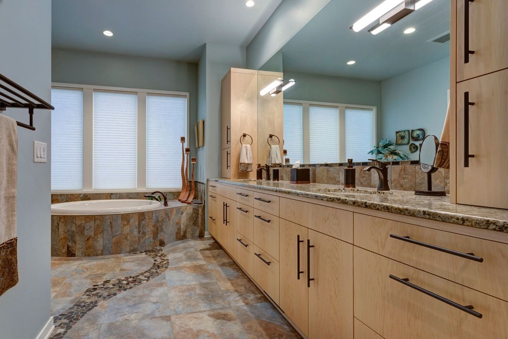 Mid-sized master bathroom in Portland with flat-panel cabinets, beige cabinets, a corner tub and blue walls.