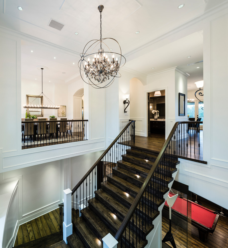 Example of a huge mountain style wooden curved mixed material railing staircase design in Vancouver with wooden risers