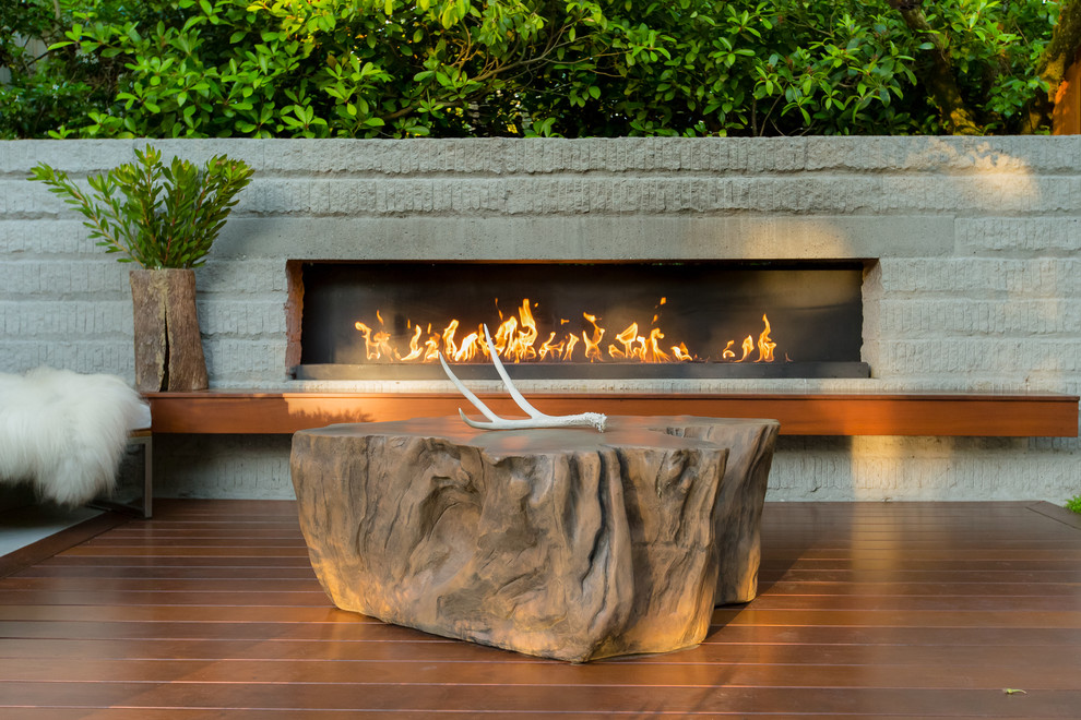 Inspiration for a mid-sized contemporary backyard deck in Seattle with with fireplace.