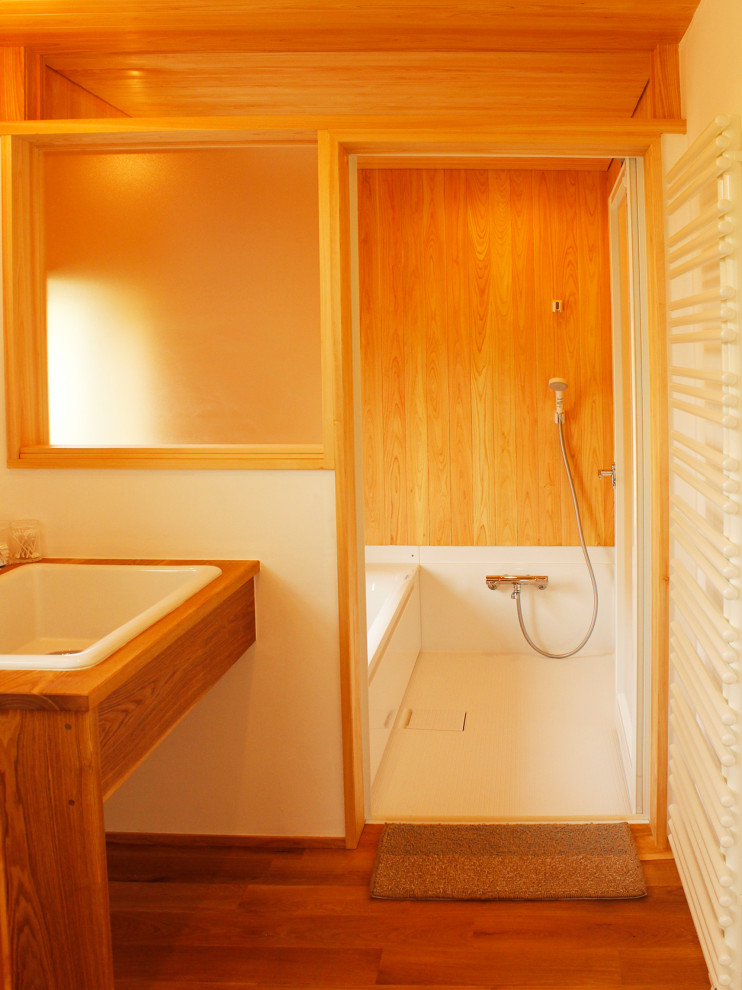 This is an example of a medium sized rustic ensuite bathroom in Other with open cabinets, medium wood cabinets, a japanese bath, white walls, medium hardwood flooring, a built-in sink, wooden worktops, brown floors, brown worktops, a single sink and a built in vanity unit.