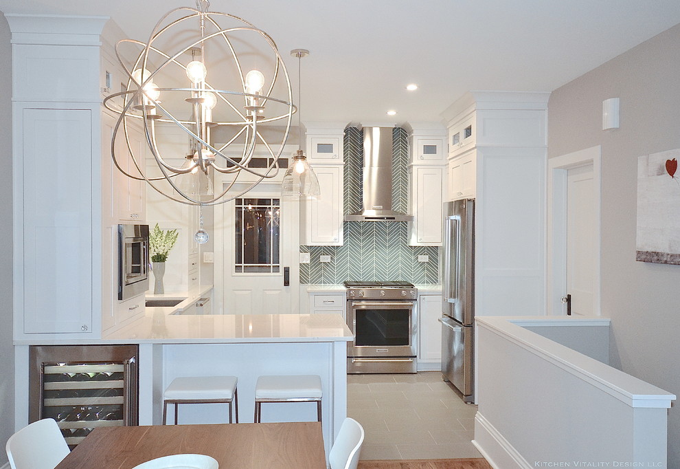 Example of a transitional kitchen design in Chicago with an undermount sink, white cabinets, quartz countertops, blue backsplash, glass tile backsplash and stainless steel appliances