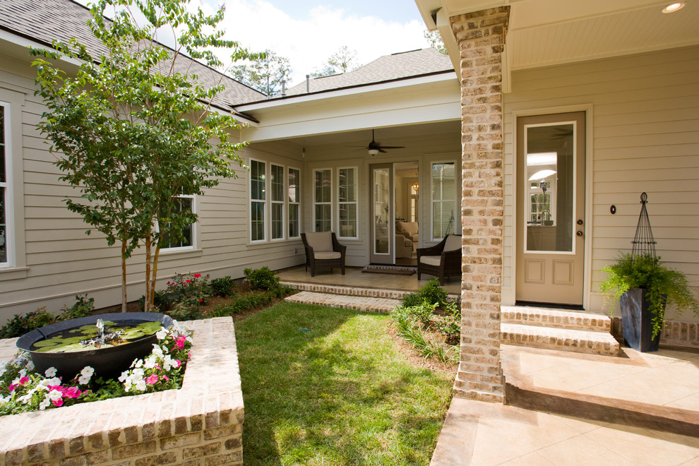 Design ideas for a mid-sized traditional two-storey brick beige exterior in New Orleans.