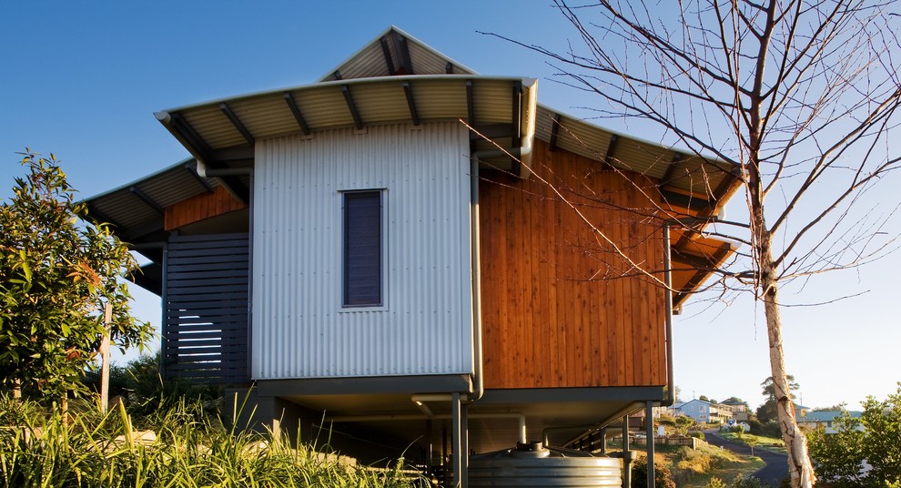 Small tropical one-storey brown exterior in Sunshine Coast with wood siding.