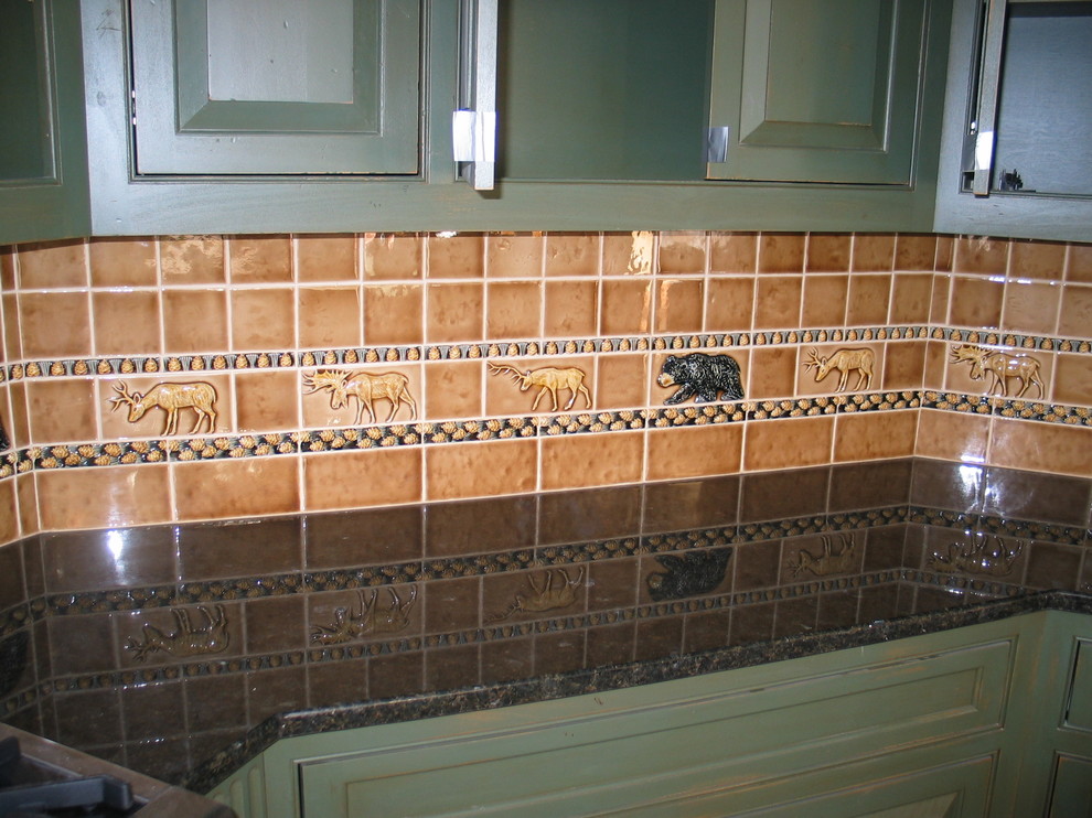 Mid-sized mountain style l-shaped enclosed kitchen photo in Burlington with an island, an undermount sink, raised-panel cabinets, blue cabinets, limestone countertops, multicolored backsplash, cement tile backsplash and stainless steel appliances