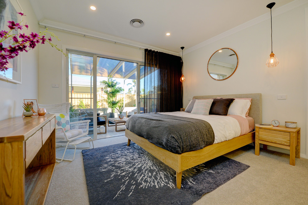 Design ideas for a beach style master bedroom in Central Coast with beige walls, carpet and beige floor.