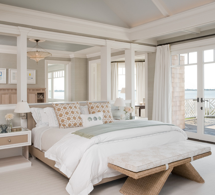 Photo of an expansive beach style bedroom in New York with beige walls and carpet.