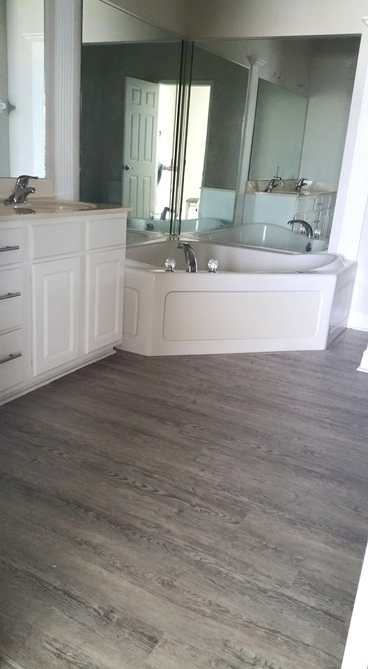 Large transitional master bathroom in Other with raised-panel cabinets, white cabinets, a corner tub, a curbless shower, beige walls, dark hardwood floors, an integrated sink and laminate benchtops.