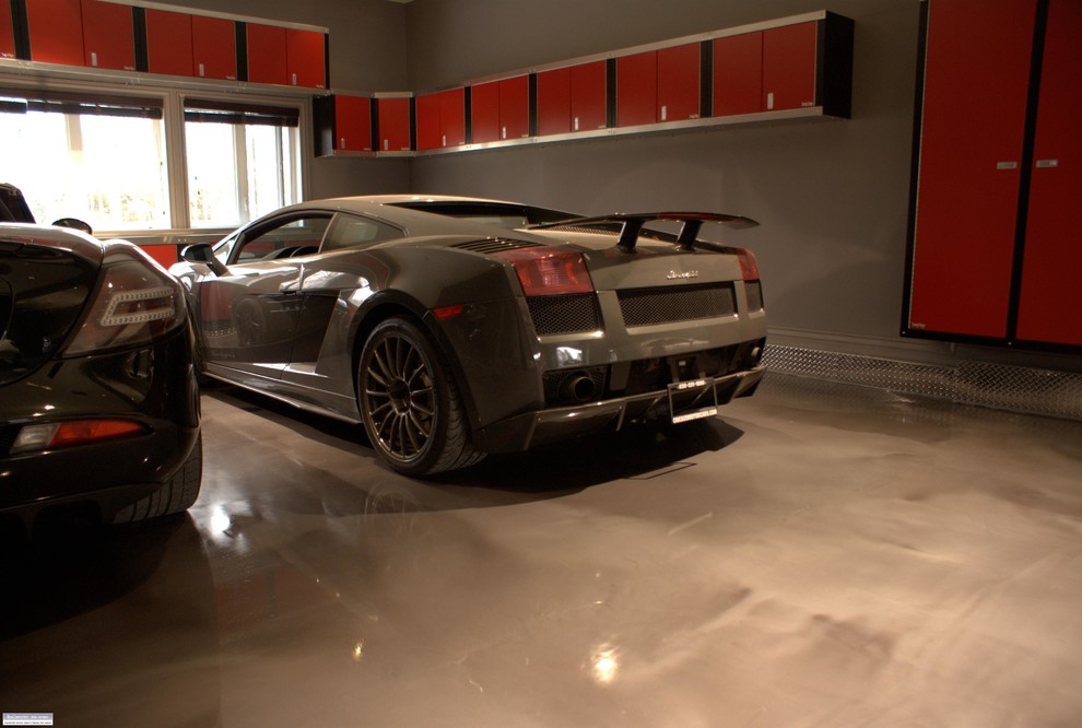 This is an example of a large contemporary attached garage in Minneapolis with three or more cars.