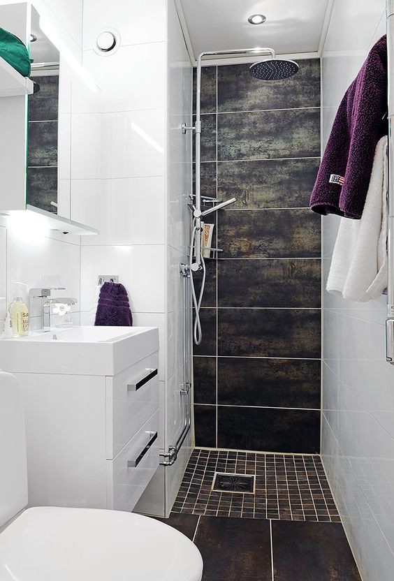 This is an example of a small modern 3/4 bathroom in Other with flat-panel cabinets, white cabinets, an alcove shower, a one-piece toilet, brown tile, porcelain tile, white walls, porcelain floors, an integrated sink, brown floor, an open shower, solid surface benchtops and white benchtops.
