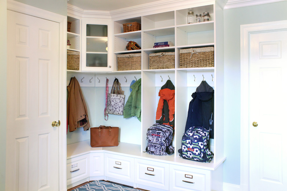 This is an example of a traditional mudroom in New York with blue walls, carpet and multi-coloured floor.