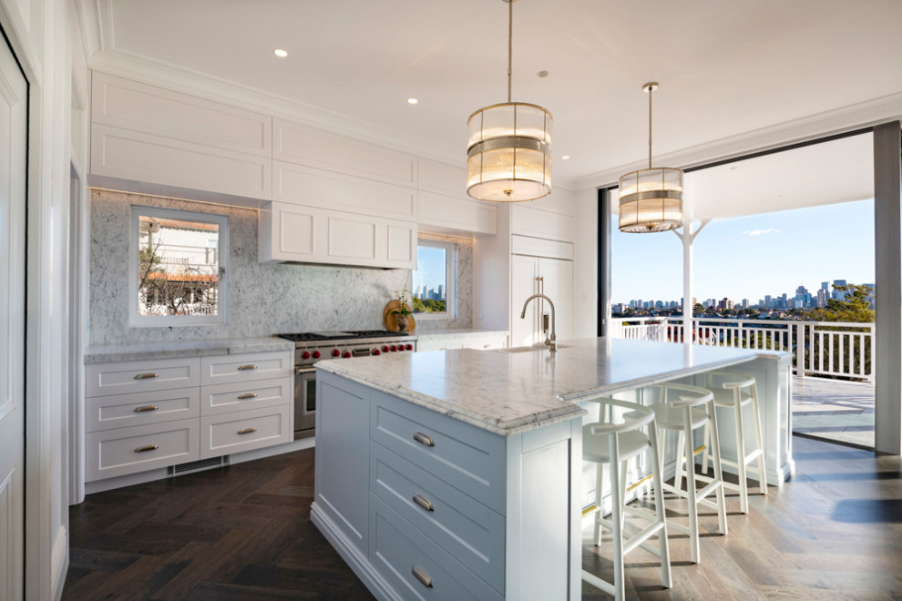 Inspiration for a mid-sized traditional l-shaped kitchen in Sydney with shaker cabinets, grey cabinets, white splashback, engineered quartz splashback, stainless steel appliances, medium hardwood floors, with island and white benchtop.