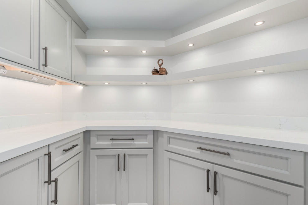 Example of a mid-sized transitional porcelain tile and gray floor eat-in kitchen design in Phoenix with an undermount sink, shaker cabinets, gray cabinets, quartz countertops, white backsplash, subway tile backsplash, stainless steel appliances, an island and white countertops