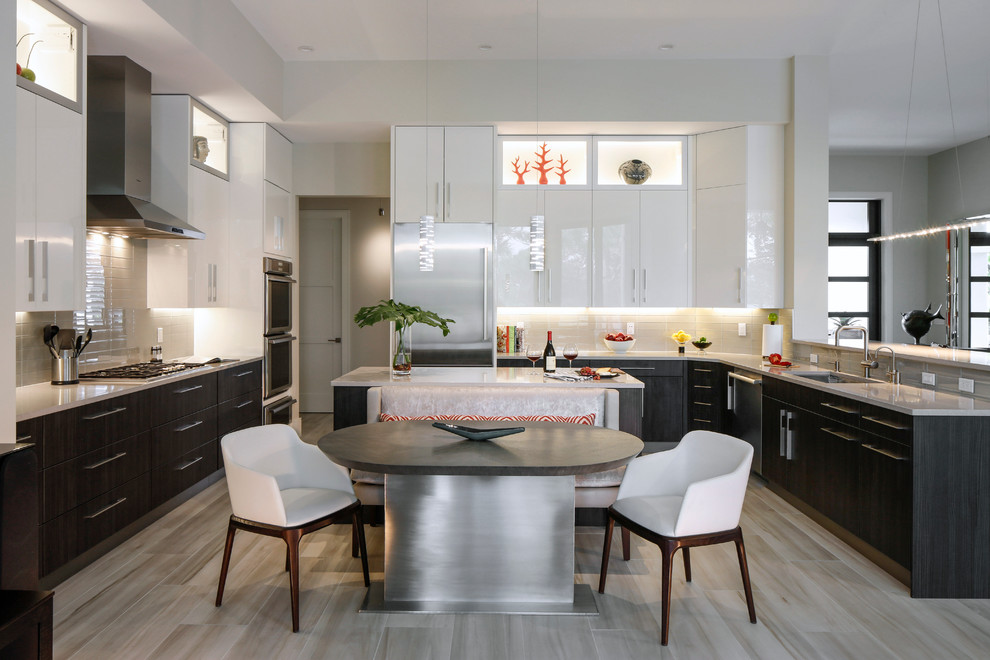 Photo of a large contemporary u-shaped eat-in kitchen in Miami with an undermount sink, dark wood cabinets, stainless steel appliances and multiple islands.