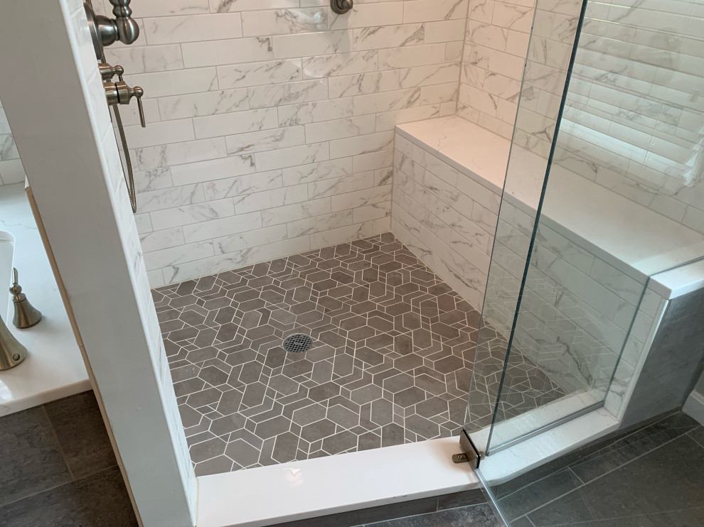 Example of a large transitional master white tile and porcelain tile porcelain tile, gray floor and double-sink alcove shower design in Cincinnati with recessed-panel cabinets, white cabinets, an undermount tub, a two-piece toilet, gray walls, an undermount sink, quartz countertops, a hinged shower door, white countertops and a built-in vanity