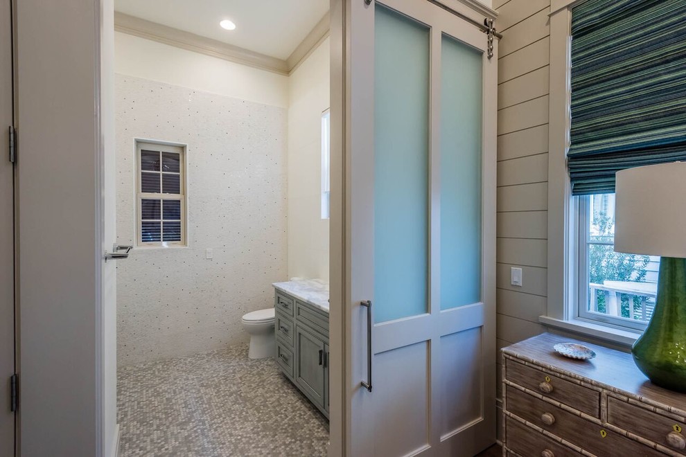 Mid-sized transitional 3/4 bathroom in Miami with beaded inset cabinets, distressed cabinets, a one-piece toilet, gray tile, white tile, glass tile, white walls, pebble tile floors, an undermount sink and marble benchtops.
