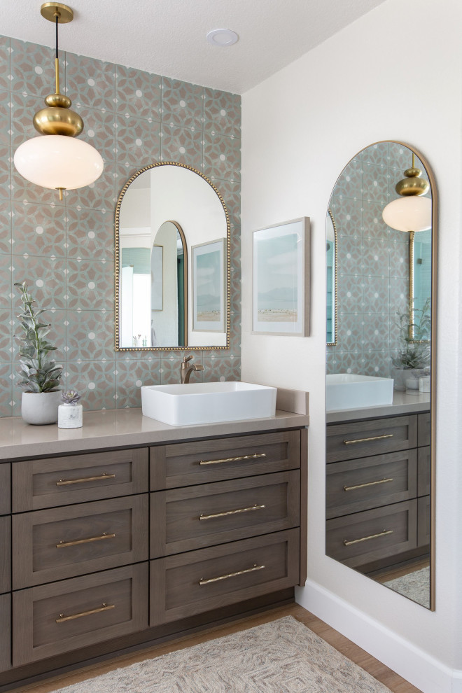 Mid-sized beach style bathroom in San Diego with shaker cabinets, a corner shower, blue tile, porcelain tile, blue walls, laminate floors, a vessel sink, engineered quartz benchtops, brown floor, a hinged shower door, blue benchtops, a double vanity and a built-in vanity.