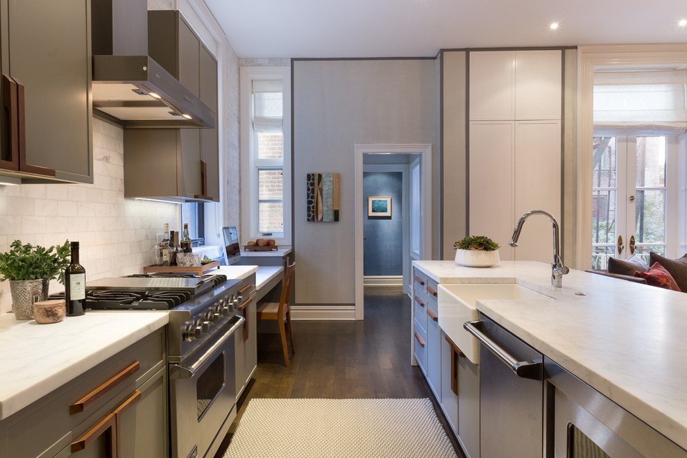 Design ideas for a mid-sized contemporary single-wall separate kitchen in New York with a farmhouse sink, flat-panel cabinets, grey cabinets, marble benchtops, white splashback, ceramic splashback, stainless steel appliances, medium hardwood floors, with island and brown floor.