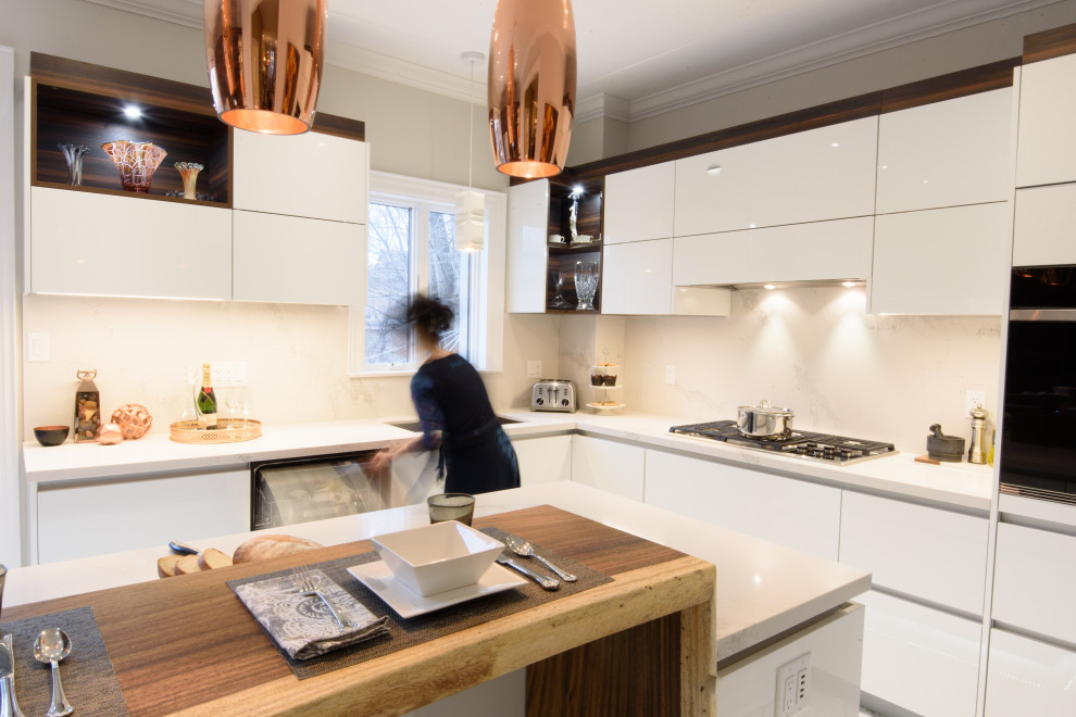 Design ideas for a large modern l-shaped separate kitchen in Toronto with an undermount sink, flat-panel cabinets, white cabinets, quartz benchtops, white splashback, engineered quartz splashback, stainless steel appliances, porcelain floors, with island, white floor and white benchtop.