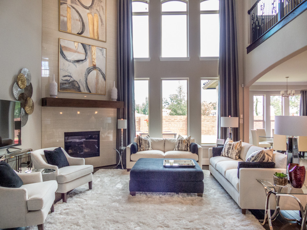 Photo of a large transitional open concept living room in Houston with a music area, beige walls, dark hardwood floors, a standard fireplace, a tile fireplace surround, a freestanding tv and brown floor.