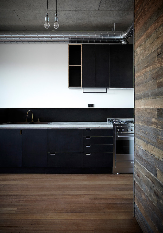 Photo of a small industrial single-wall eat-in kitchen in Melbourne with no island.