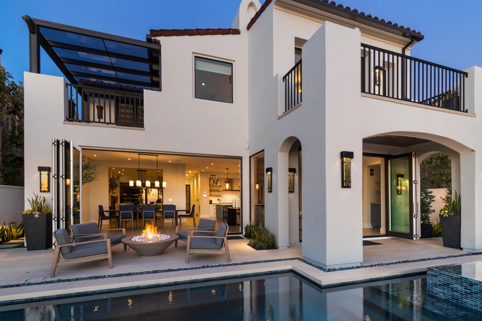 This is an example of a medium sized and white nautical two floor render detached house in San Diego with a tiled roof and a red roof.