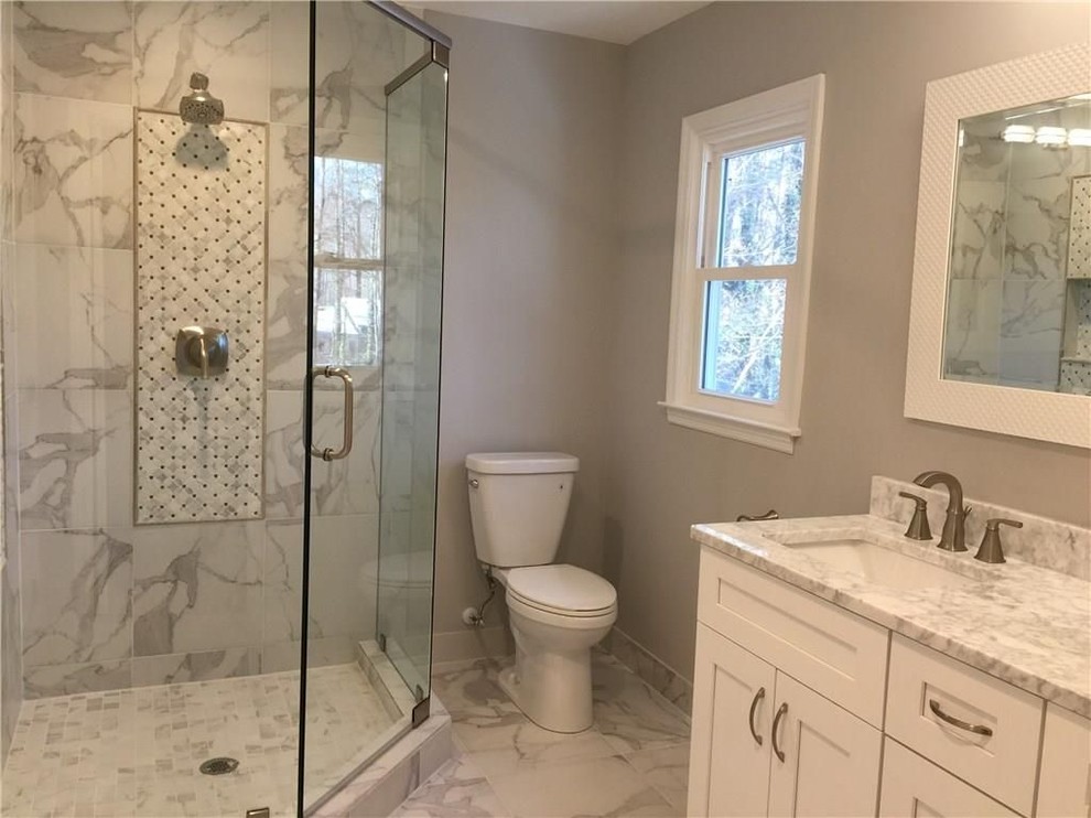 This is an example of a mid-sized traditional master bathroom in Atlanta with shaker cabinets, white cabinets, a corner shower, grey walls, marble floors, an undermount sink and granite benchtops.