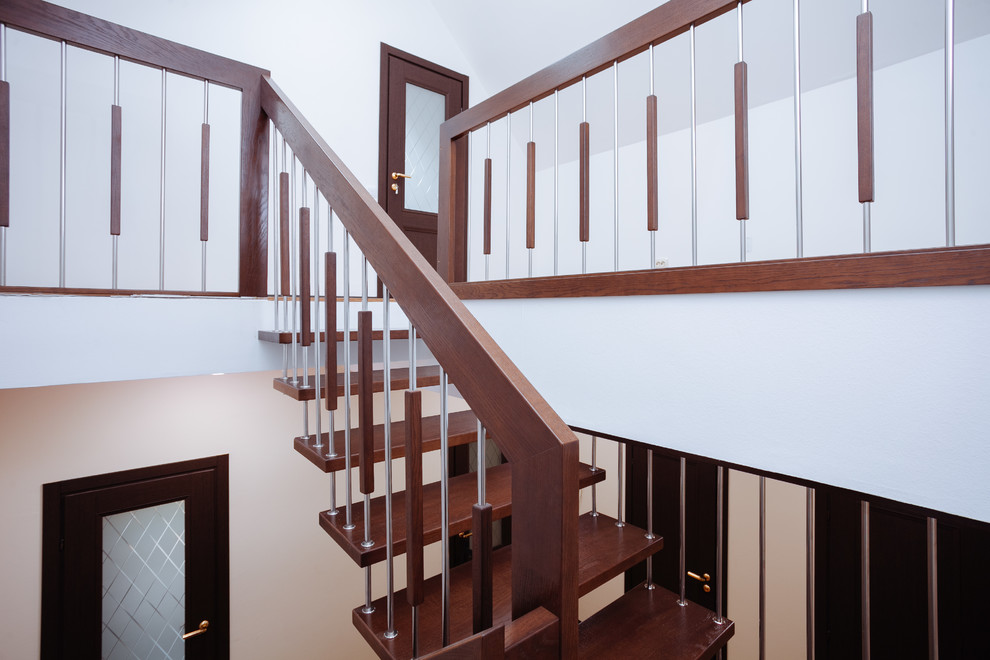 Inspiration for a mid-sized contemporary wood u-shaped staircase in Other with mixed railing.