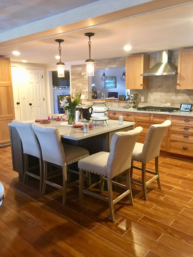 Inspiration for a transitional eat-in kitchen remodel in Boston with a farmhouse sink, quartz countertops and an island
