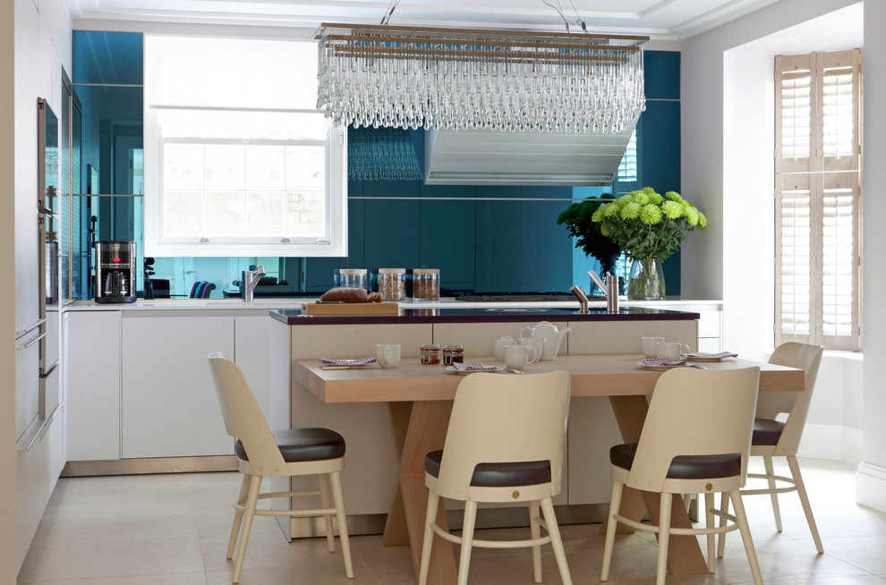 Inspiration for a contemporary l-shaped eat-in kitchen in London with flat-panel cabinets, white cabinets, blue splashback, with island and beige floor.