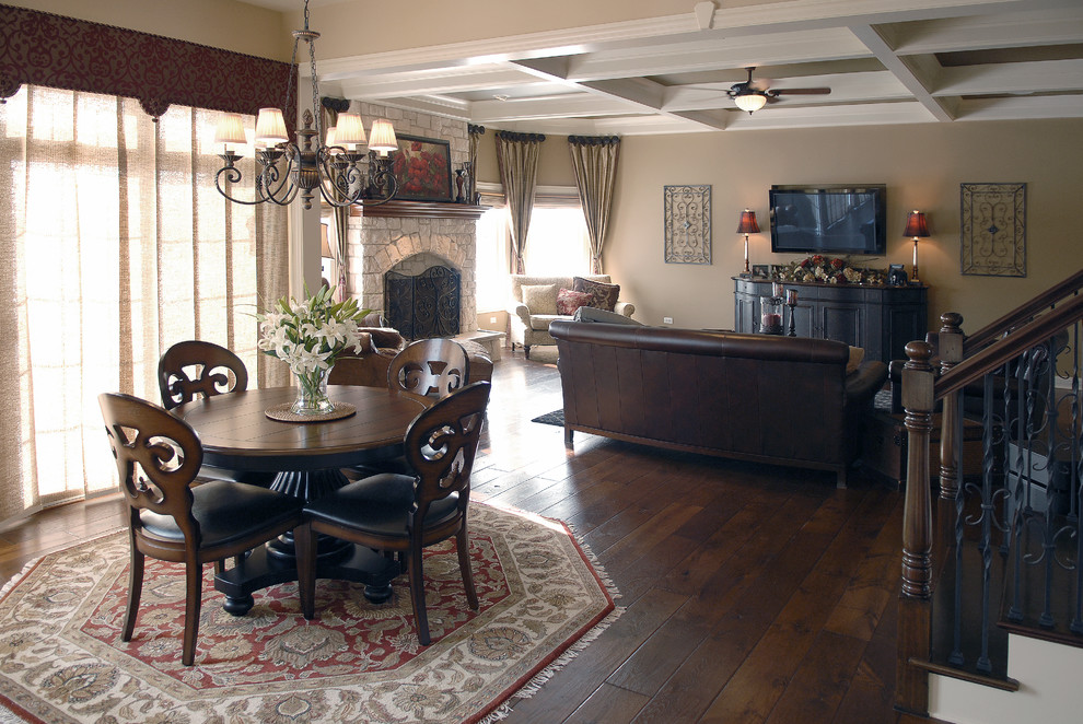 Inspiration for a large traditional living room in Chicago with beige walls, dark hardwood floors, a standard fireplace, a stone fireplace surround, a wall-mounted tv, brown floor and coffered.