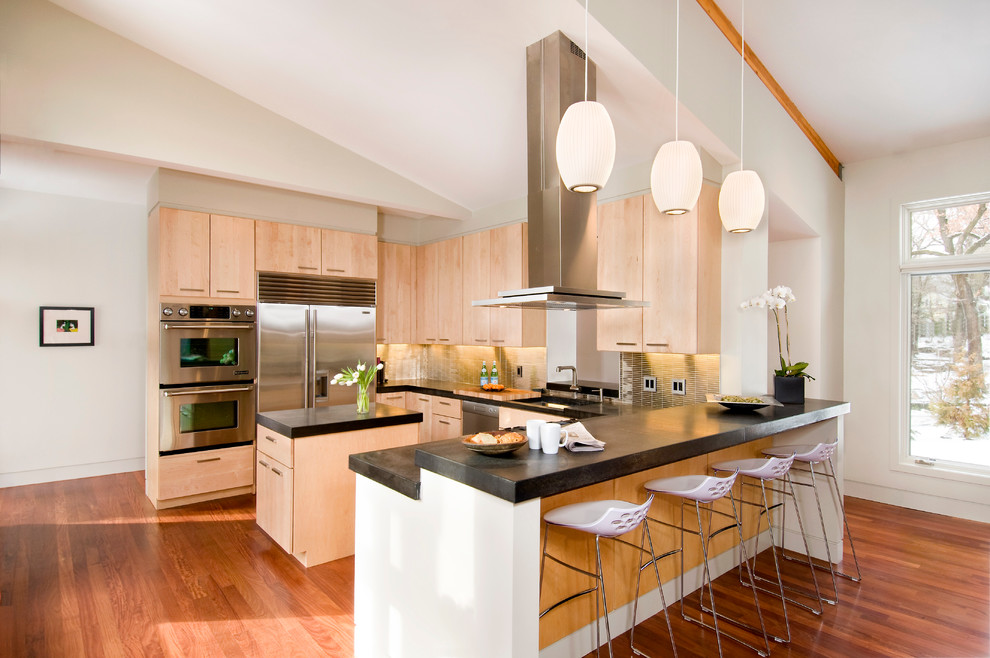 Contemporary kitchen in Boston with flat-panel cabinets, light wood cabinets, metallic splashback, stainless steel appliances, dark hardwood floors and with island.