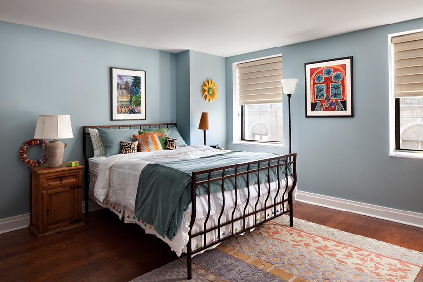 Design ideas for a mid-sized transitional master bedroom in New York with blue walls, medium hardwood floors and no fireplace.