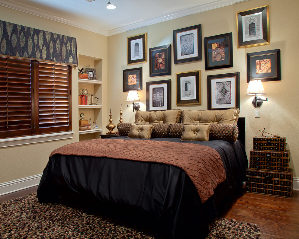 This is an example of a mid-sized traditional bedroom in Orlando with beige walls, dark hardwood floors and no fireplace.