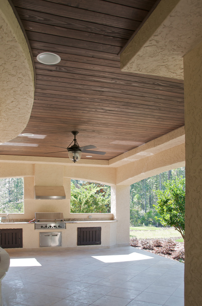 Example of a large classic backyard tile patio kitchen design in Charlotte with a roof extension
