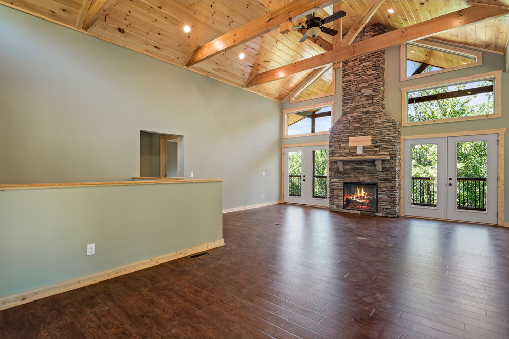 Foyer - large rustic laminate floor and brown floor foyer idea with green walls and a medium wood front door