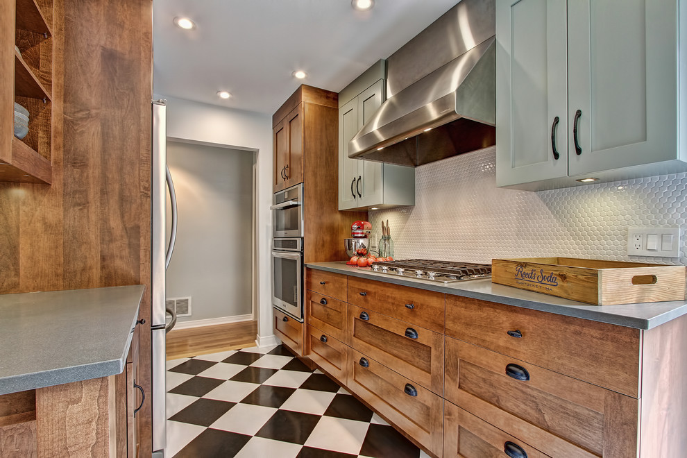 Eclectic kitchen in Toronto with a farmhouse sink, white splashback, ceramic splashback, stainless steel appliances, recessed-panel cabinets, green cabinets, soapstone benchtops and ceramic floors.