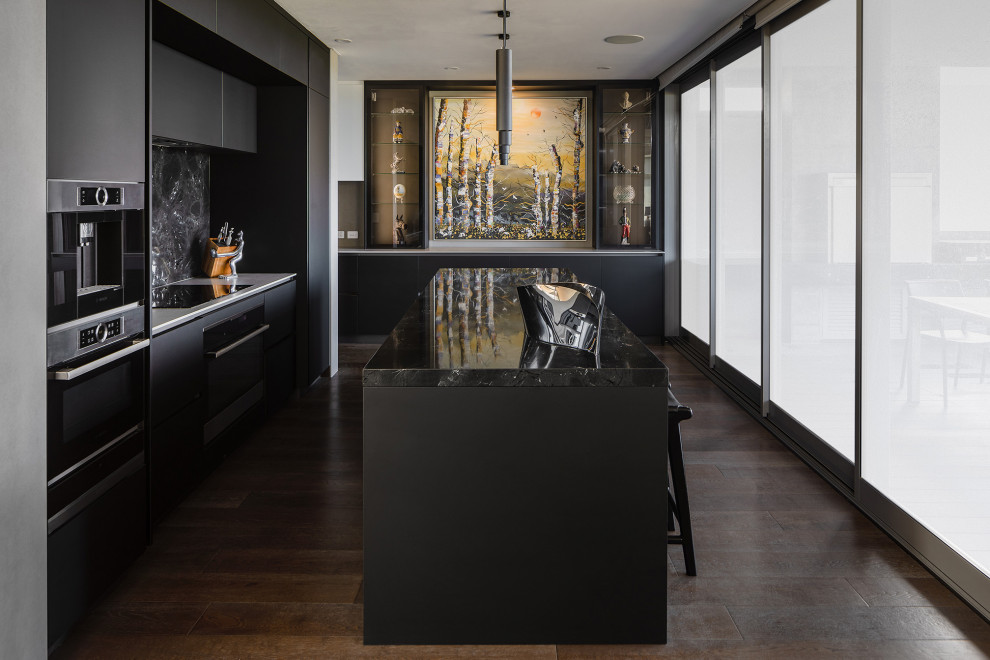 This is an example of a large contemporary eat-in kitchen in Perth with black cabinets, granite benchtops, medium hardwood floors, with island and black benchtop.