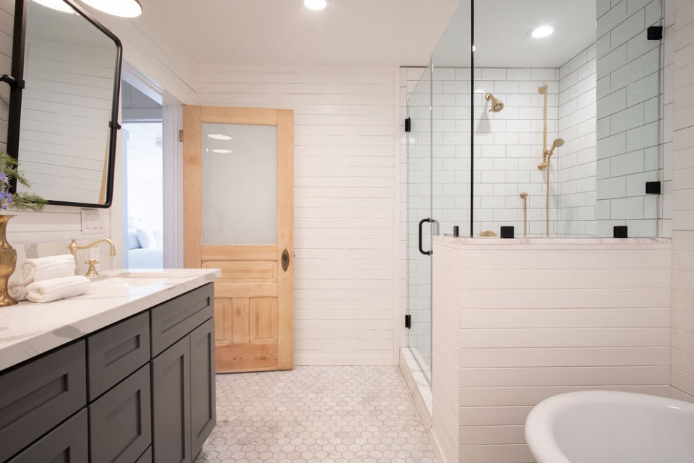 This is an example of a small traditional master bathroom in Sacramento with shaker cabinets, grey cabinets, a one-piece toilet, white tile, subway tile, white walls, marble floors, a drop-in sink, quartzite benchtops, white floor, a hinged shower door, white benchtops, a shower seat, a double vanity, a built-in vanity, wood and panelled walls.