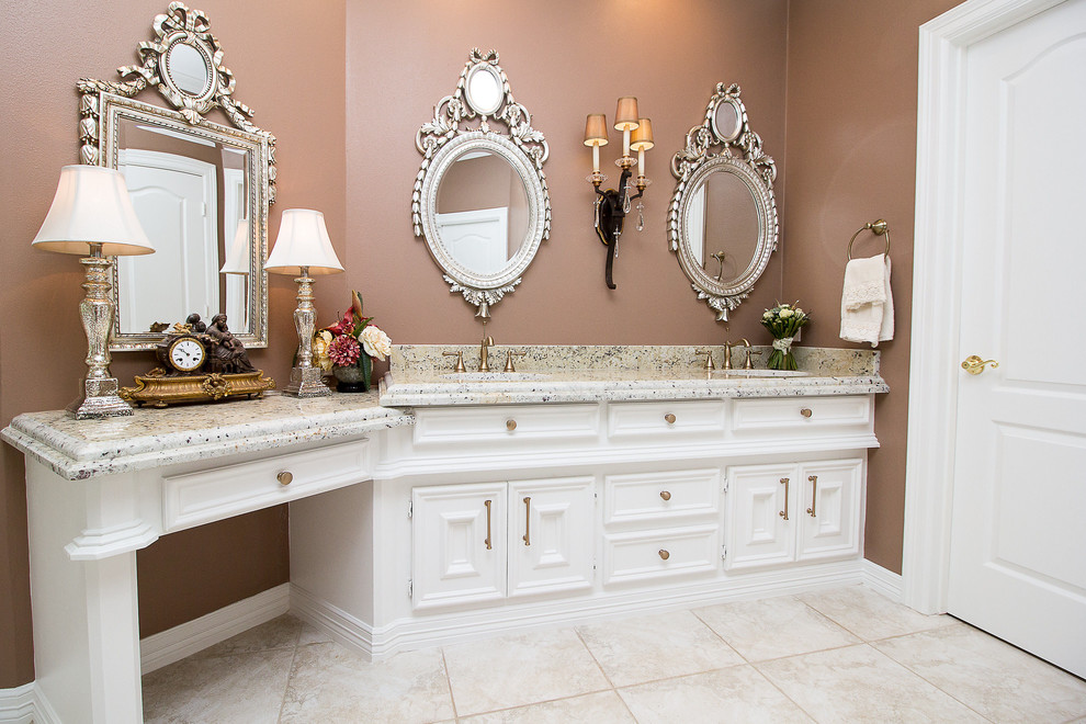 Example of a mid-sized classic master white tile and porcelain tile porcelain tile and beige floor alcove bathtub design in Houston with recessed-panel cabinets, white cabinets, brown walls, an undermount sink, granite countertops and a hinged shower door