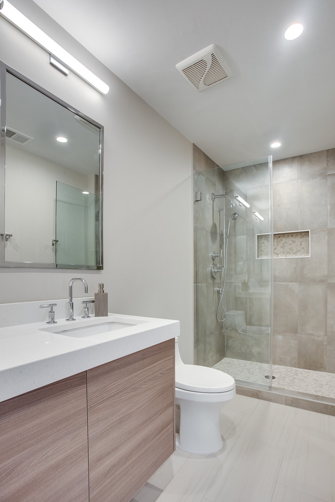 Inspiration for a small modern master bathroom in DC Metro with flat-panel cabinets, brown cabinets, a one-piece toilet, gray tile, porcelain tile, grey walls, porcelain floors, an undermount sink, engineered quartz benchtops, grey floor, a hinged shower door and yellow benchtops.