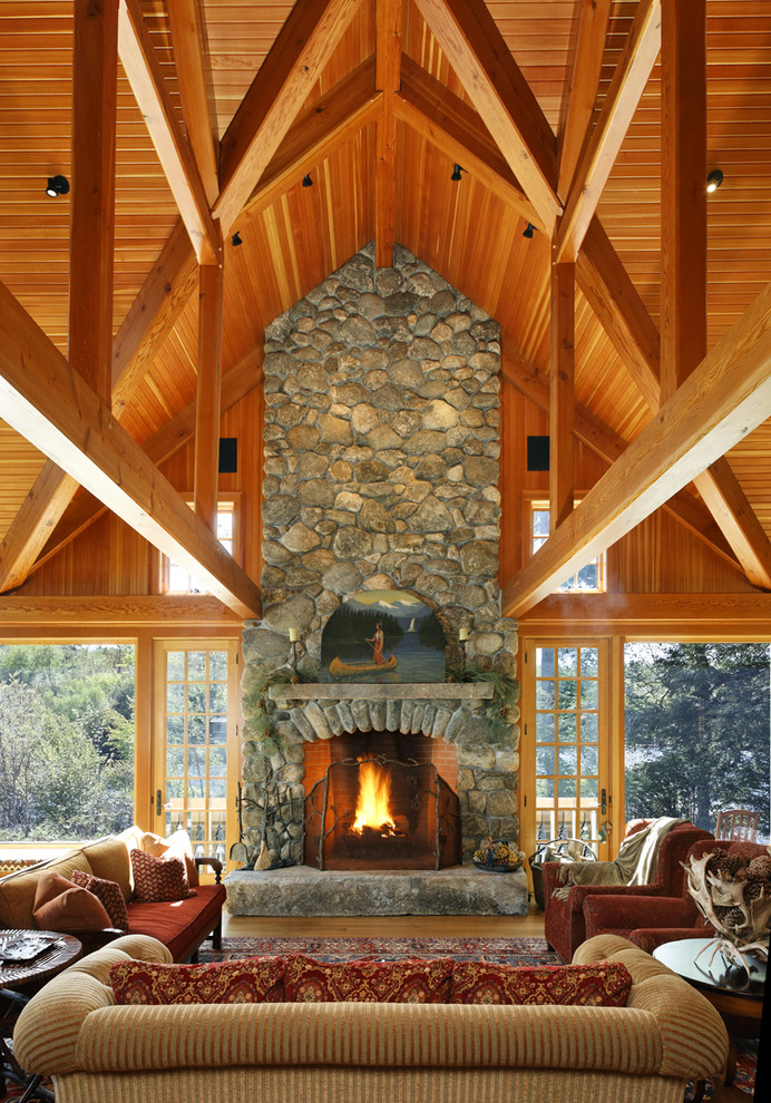 Country open concept family room in Boston with a standard fireplace and a stone fireplace surround.