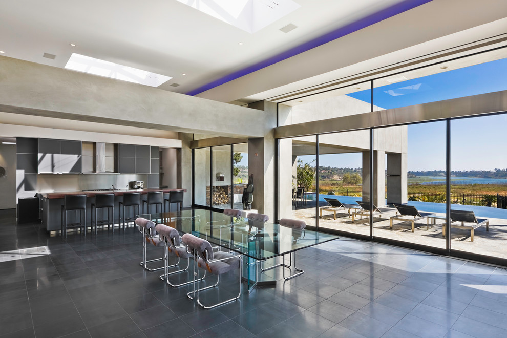 Example of a large trendy gray floor kitchen/dining room combo design in Orange County with gray walls