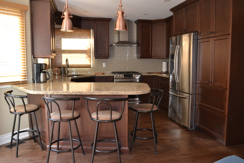 Kitchen pantry - mid-sized transitional u-shaped medium tone wood floor kitchen pantry idea in Toronto with an undermount sink, recessed-panel cabinets, medium tone wood cabinets, quartz countertops, beige backsplash, glass sheet backsplash, stainless steel appliances and a peninsula