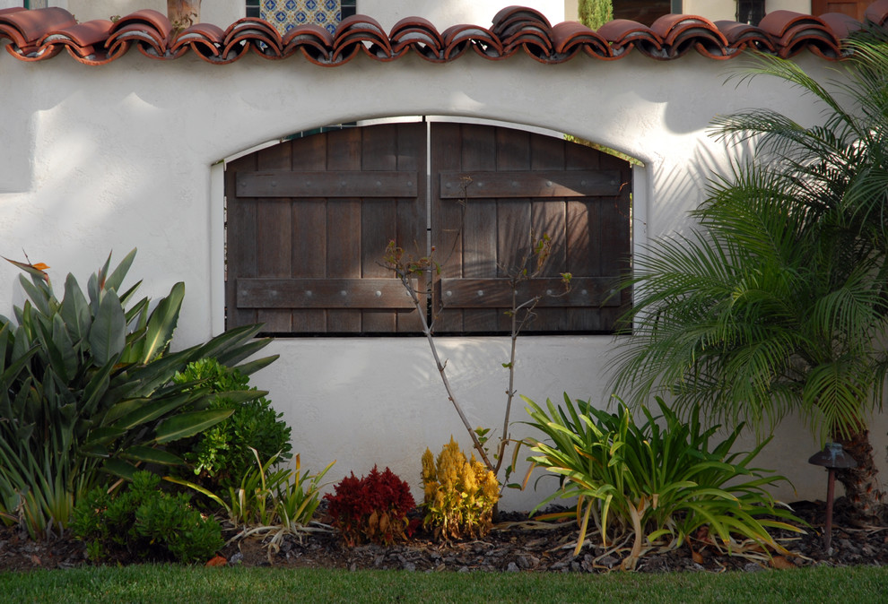 Photo of a large mediterranean two-storey stucco exterior in San Diego.