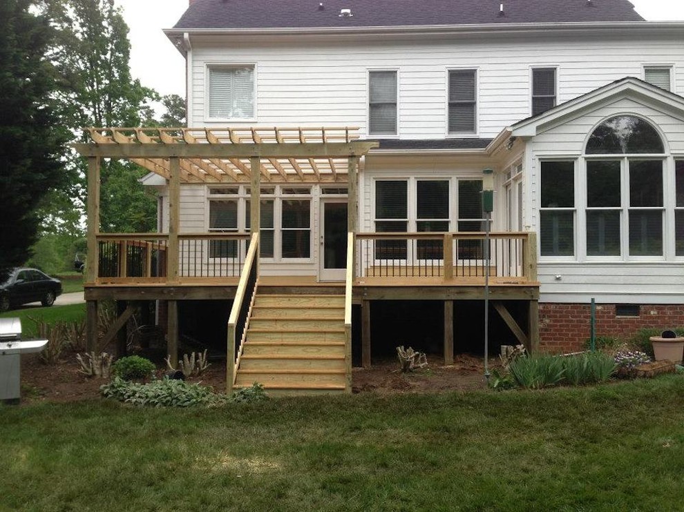 Small transitional side yard balcony deck photo in Raleigh with a pergola