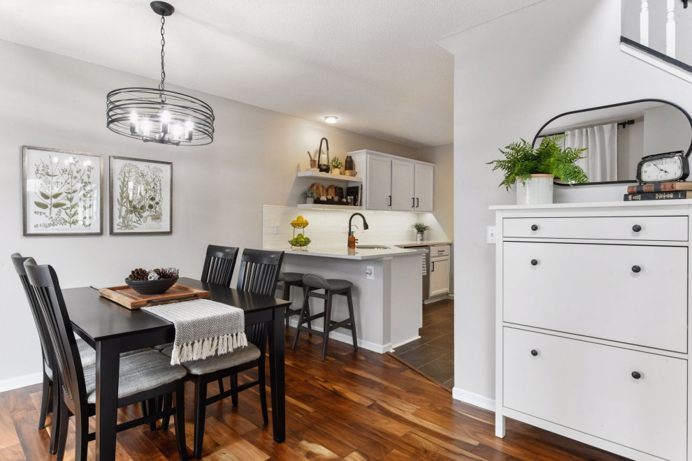Small transitional kitchen/dining combo in Minneapolis with grey walls, laminate floors, no fireplace and brown floor.