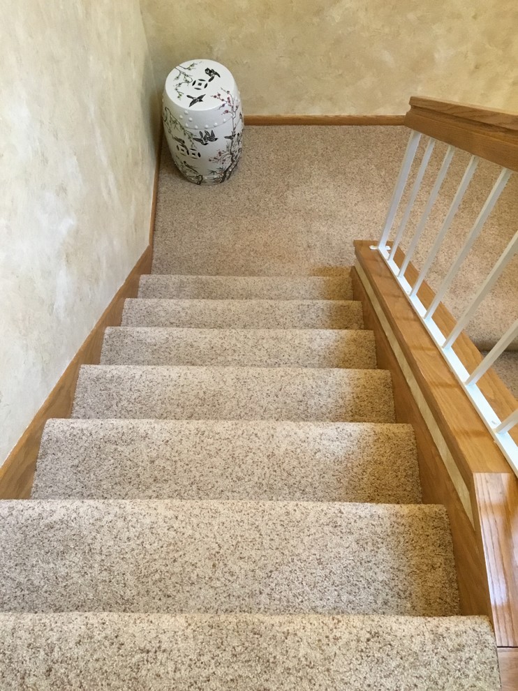 Inspiration for a mid-sized transitional carpeted l-shaped staircase in Minneapolis with carpet risers and wood railing.