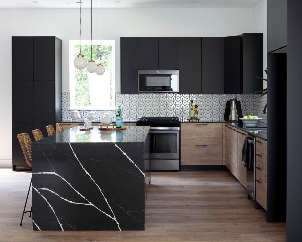 Contemporary l-shaped kitchen in Charlotte with flat-panel cabinets, black cabinets, quartz benchtops, white splashback, black benchtop, light hardwood floors, with island and beige floor.